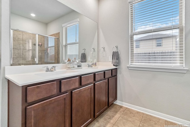 bathroom with tile patterned flooring, vanity, and a shower with shower door