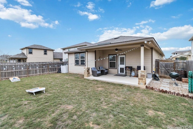 back of house featuring a yard, a patio, and ceiling fan