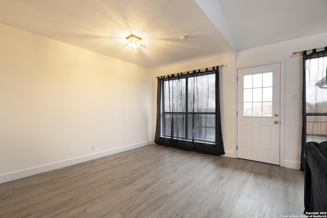 foyer with hardwood / wood-style floors and a textured ceiling