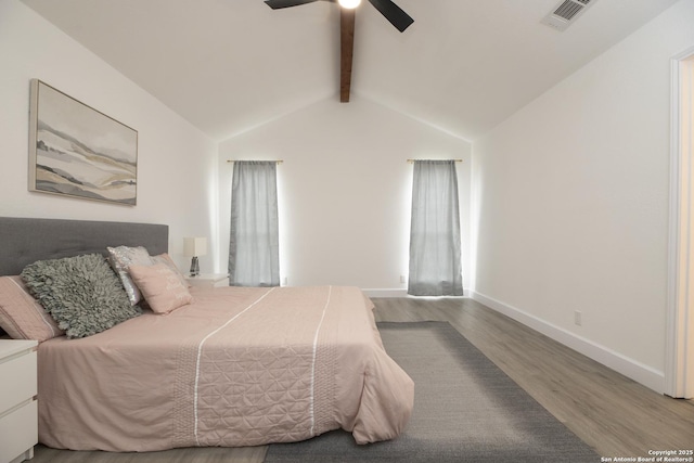 bedroom featuring ceiling fan, lofted ceiling with beams, and hardwood / wood-style flooring