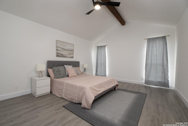 bedroom featuring hardwood / wood-style floors, lofted ceiling with beams, and ceiling fan