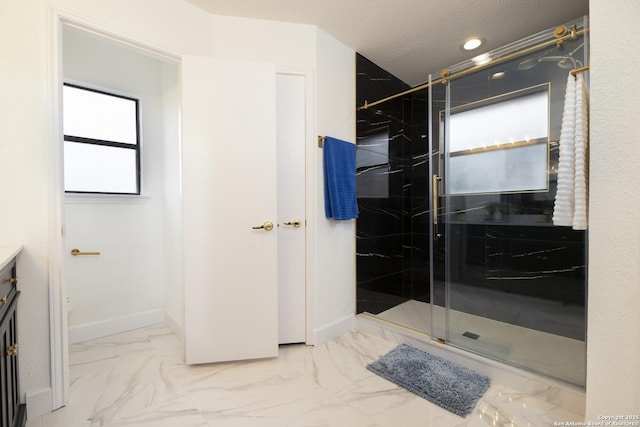 bathroom with vanity and a shower with door