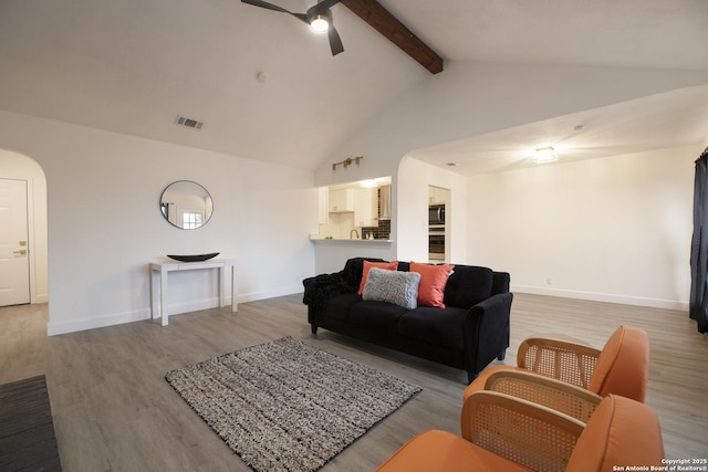 living room featuring wood-type flooring, high vaulted ceiling, ceiling fan, and beam ceiling