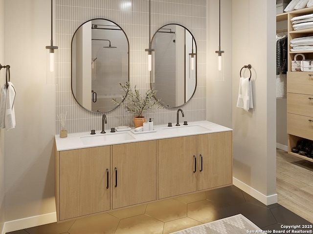 bathroom with backsplash, tile patterned flooring, vanity, and an enclosed shower