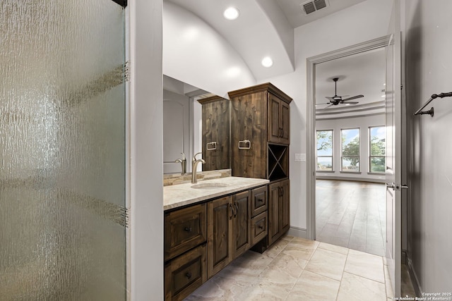 bathroom featuring ceiling fan, vanity, and a shower with shower door