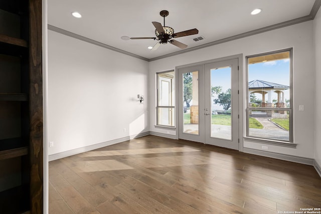 interior space featuring ceiling fan, crown molding, hardwood / wood-style floors, and french doors