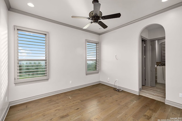 spare room with ceiling fan, plenty of natural light, ornamental molding, and hardwood / wood-style flooring