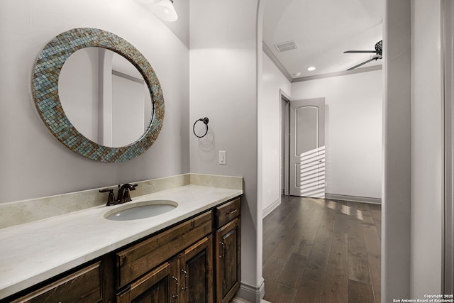 bathroom featuring ceiling fan, hardwood / wood-style floors, and vanity