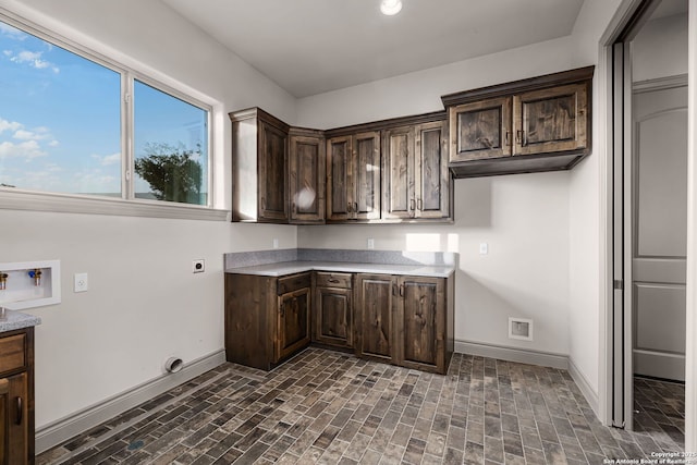 laundry room featuring washer hookup, electric dryer hookup, and cabinets