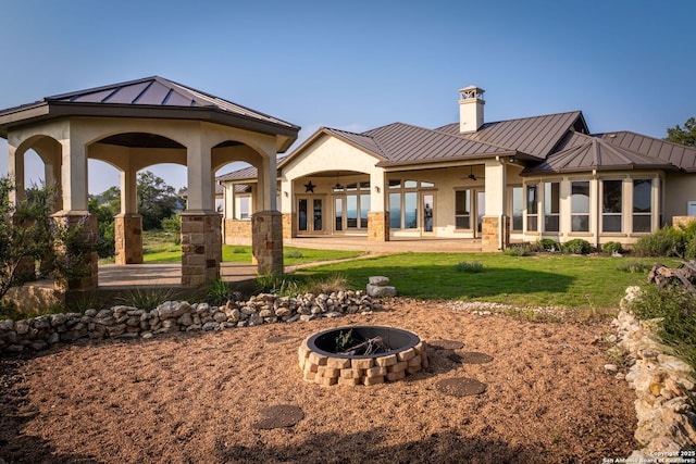 back of property with ceiling fan, a yard, and french doors