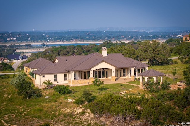 rear view of house featuring a gazebo