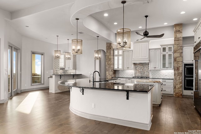 kitchen featuring a kitchen bar, pendant lighting, and a large island