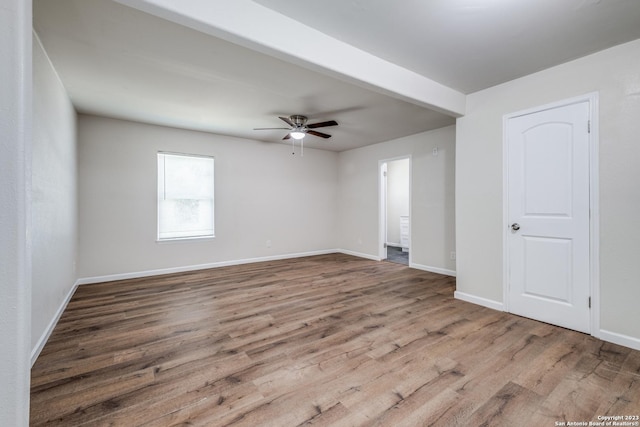 empty room with hardwood / wood-style flooring and ceiling fan