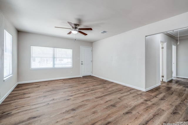 unfurnished room with hardwood / wood-style flooring and ceiling fan