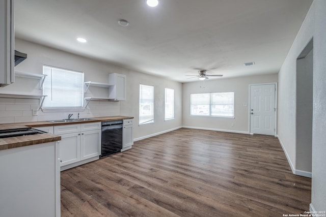 kitchen with white cabinets, sink, tasteful backsplash, plenty of natural light, and butcher block counters