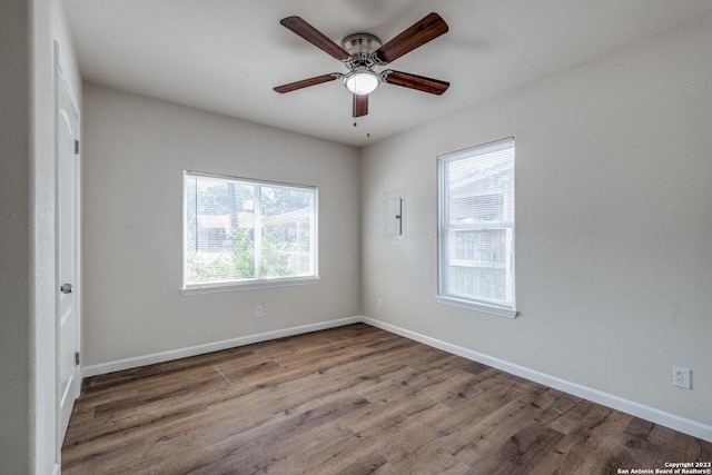 spare room with hardwood / wood-style flooring and ceiling fan