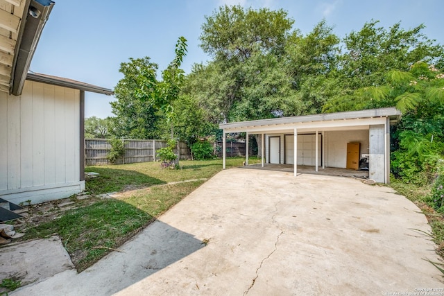 view of patio with a garage and an outdoor structure