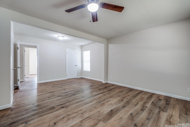 unfurnished room featuring hardwood / wood-style floors and ceiling fan