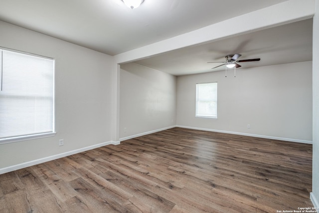 empty room with wood-type flooring and ceiling fan