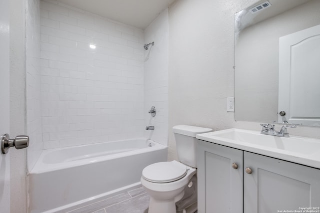 full bathroom with vanity, shower / bath combination, and toilet