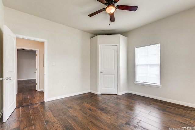 spare room featuring ceiling fan and dark wood-type flooring