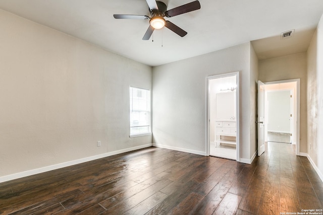 spare room with dark hardwood / wood-style flooring and ceiling fan