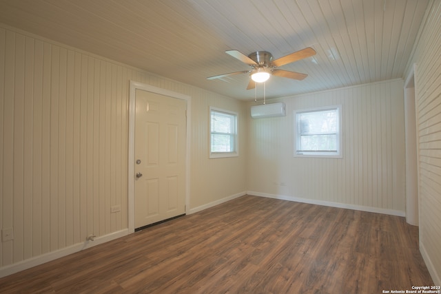 unfurnished room with an AC wall unit, ceiling fan, dark wood-type flooring, and crown molding