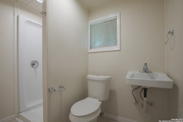 bathroom with a shower, sink, and toilet