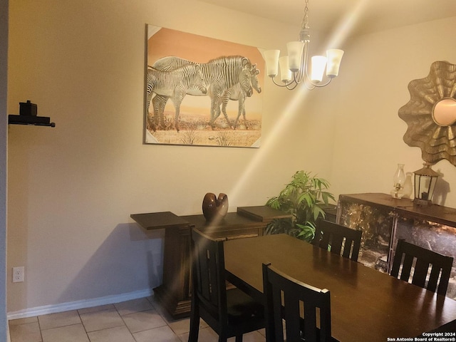 tiled dining area with a notable chandelier