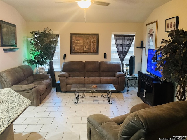 living room featuring ceiling fan, a healthy amount of sunlight, and lofted ceiling