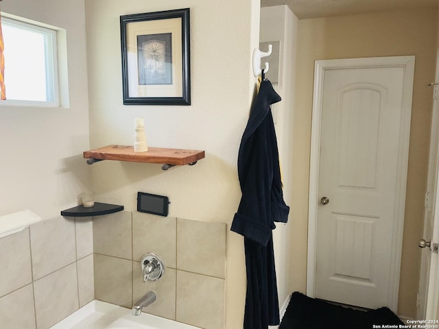 bathroom featuring a tub to relax in