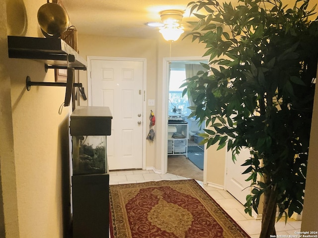 entryway with light tile patterned floors