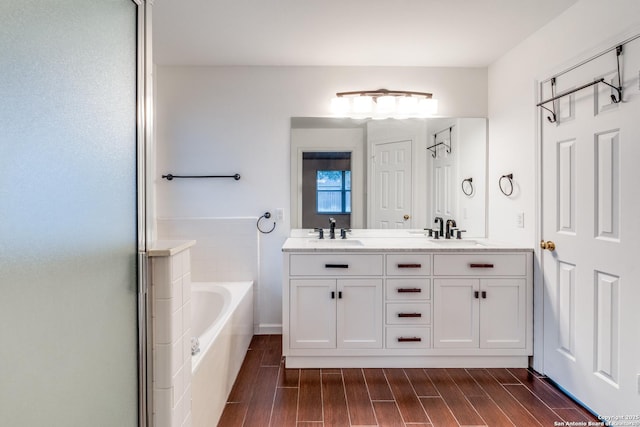 bathroom with vanity and a tub