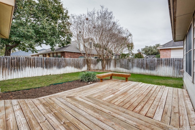 wooden deck featuring a yard