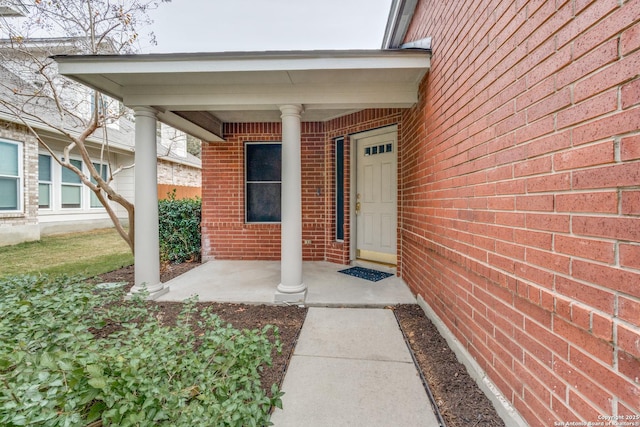 entrance to property featuring a porch