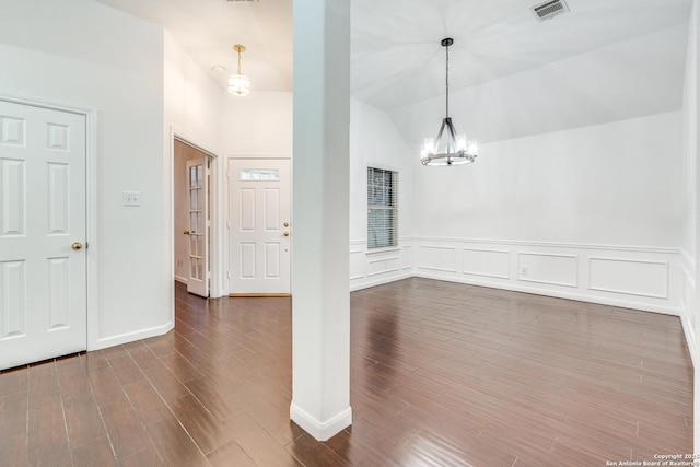 foyer with an inviting chandelier and vaulted ceiling