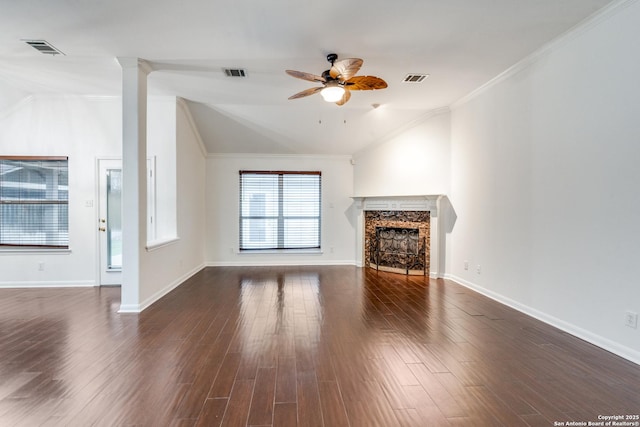 unfurnished living room featuring a premium fireplace, crown molding, ceiling fan, and dark wood-type flooring