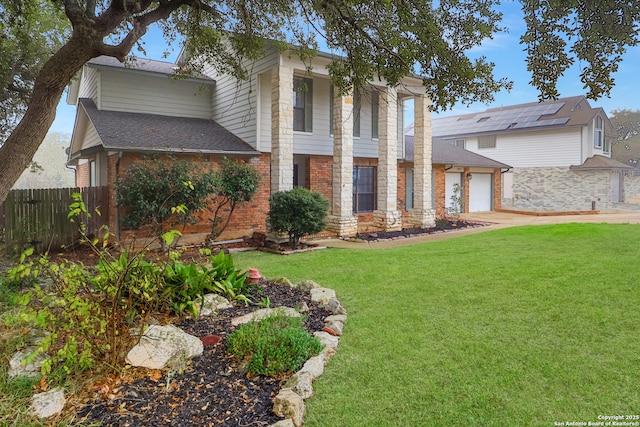 view of front of home with a front yard and a garage