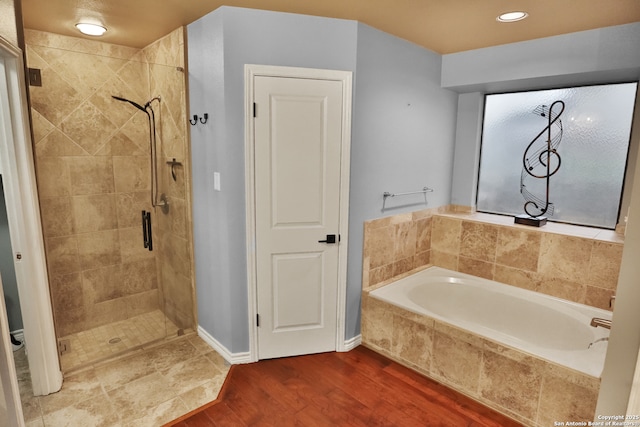 bathroom featuring independent shower and bath and wood-type flooring