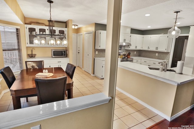 tiled dining room featuring a textured ceiling and sink