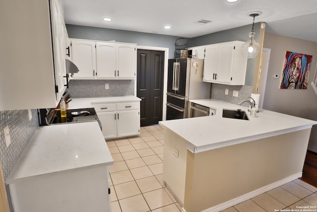 kitchen featuring white cabinets, sink, hanging light fixtures, tasteful backsplash, and stainless steel appliances