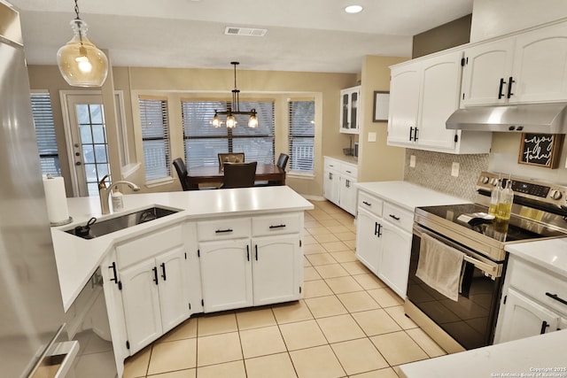 kitchen with pendant lighting, backsplash, white cabinets, sink, and stainless steel appliances