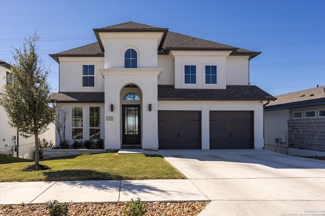 view of front of property with a garage and a front lawn