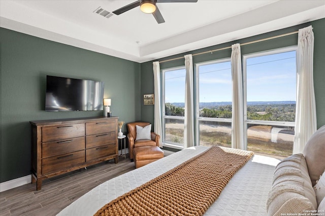 bedroom with ceiling fan and multiple windows