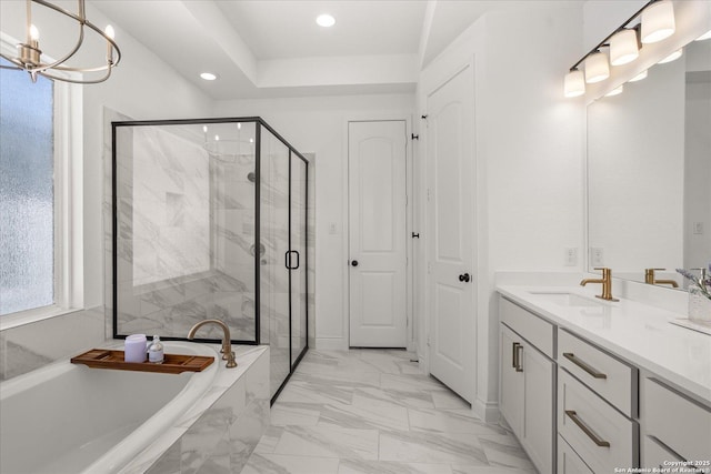 bathroom with vanity, independent shower and bath, and an inviting chandelier