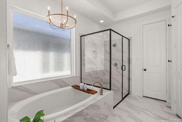 bathroom featuring separate shower and tub and an inviting chandelier