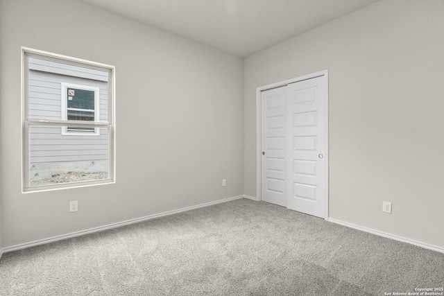 unfurnished bedroom with carpet flooring and a closet