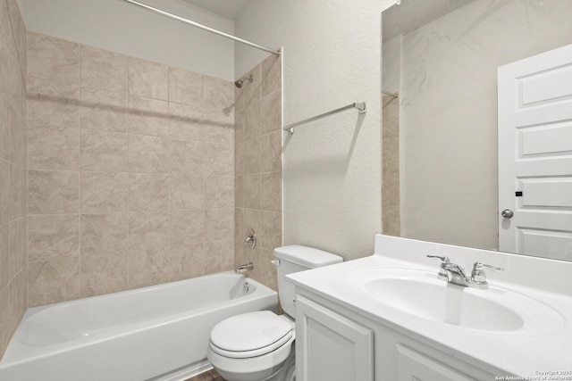 full bathroom with vanity, toilet, and tiled shower / bath