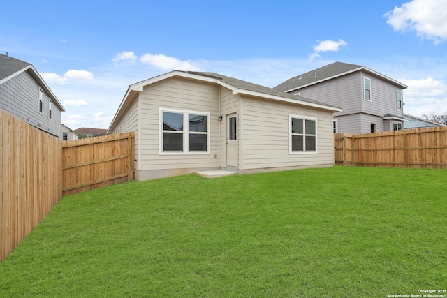 rear view of house featuring a lawn