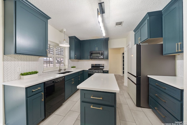 kitchen featuring a kitchen island, sink, hanging light fixtures, blue cabinetry, and stainless steel appliances